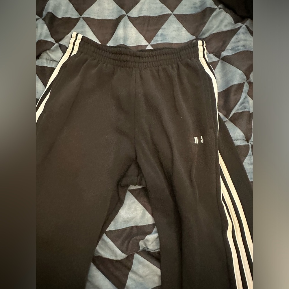 Medium sized black Adidas track pants
